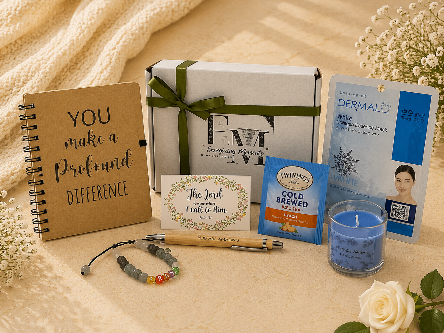 Gifting set with notebook, card, box, and other items on a textured surface.