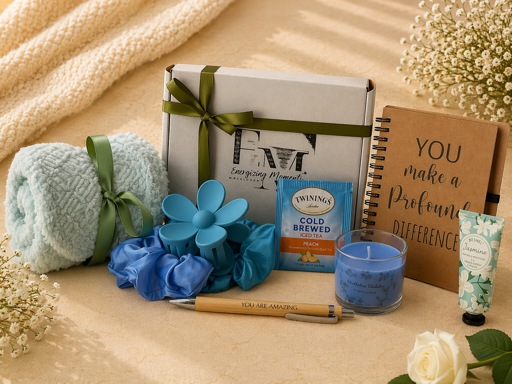 Gift set with bath products, tea, and a card on a wooden surface.