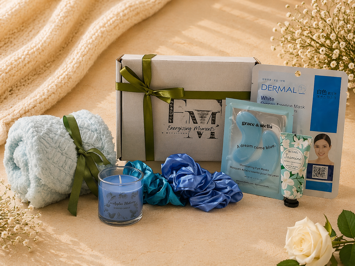 Gifting set with bath towel, candle, and skincare products on a textured surface.