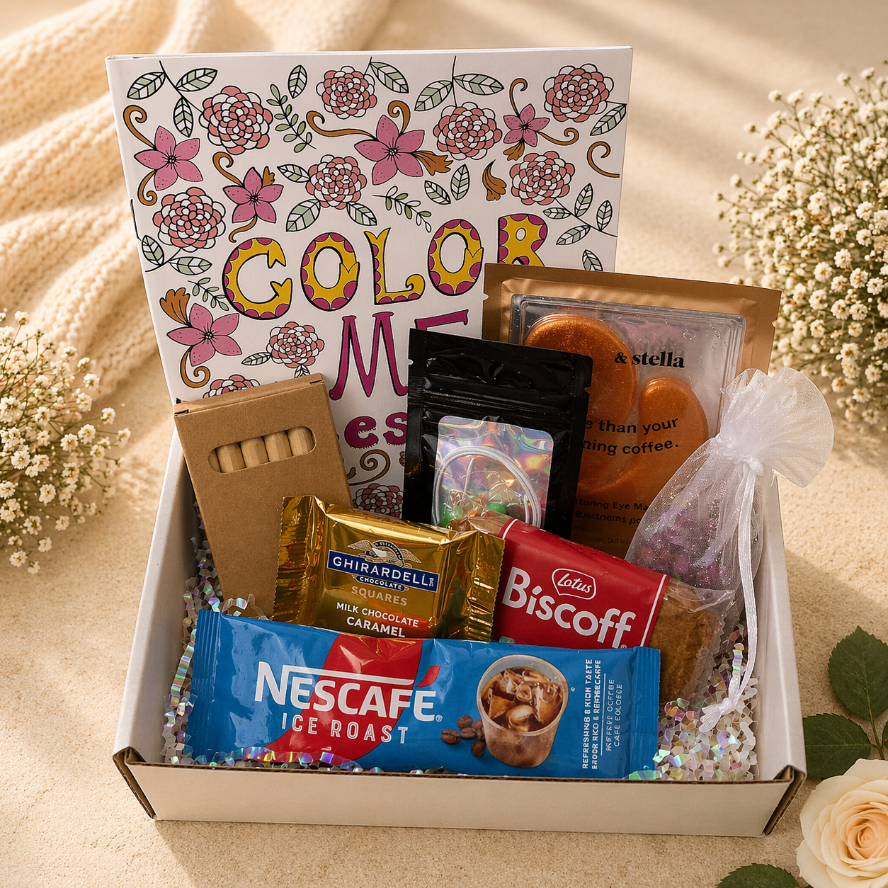 Gift box with snacks, a coloring book, and a candle on a beige surface.