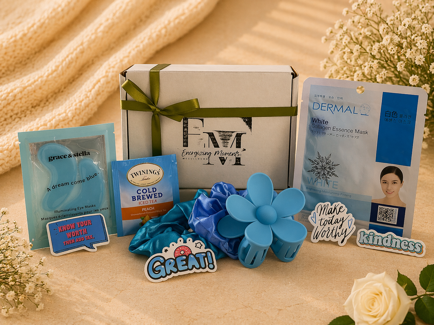 Collection of items including a box, flowers, and various products on a textured surface.